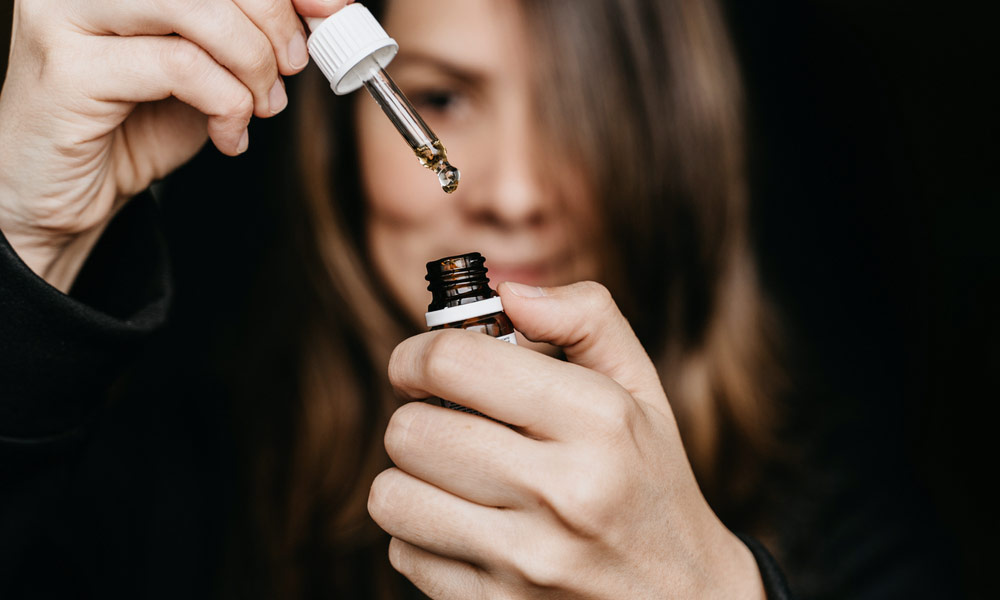 A women is figuring out CBD Oil Dosage