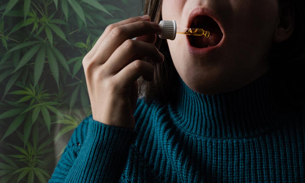 A women is taking CBD Oil Under Tongue