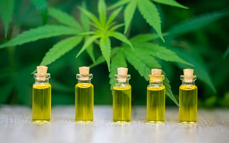CBD Oil Bottles and cannabis Leaf