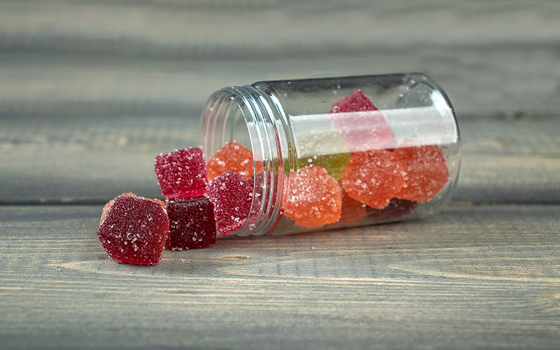 A Bottle is Laid Down with Full of Gummies